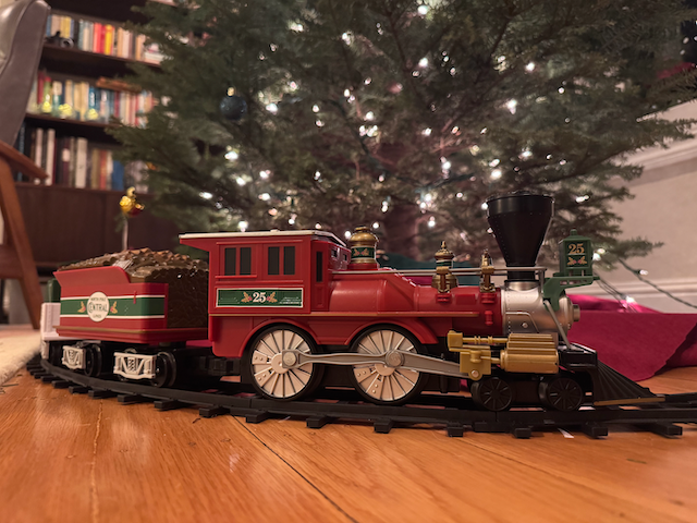 Lionel "North Pole Central" train in front of a Christmas tree